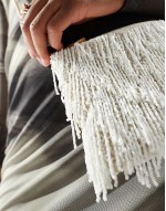 tassle clutch bag with crossbody chain in cream
